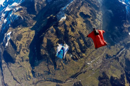 Aerial view two wingsuits flying above landscape