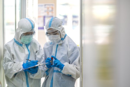 Doctors wearing PPE suit and face mask