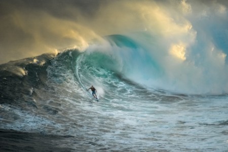 man riding a large wave