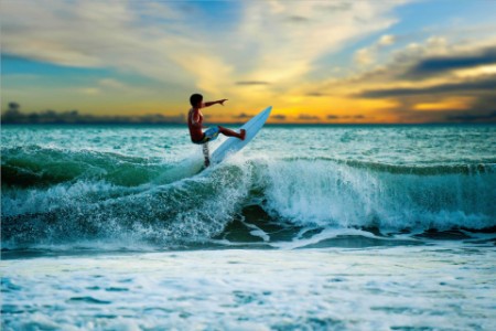 Athletic surfer with board