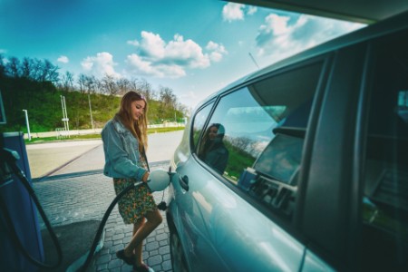 Woman refilling car gas