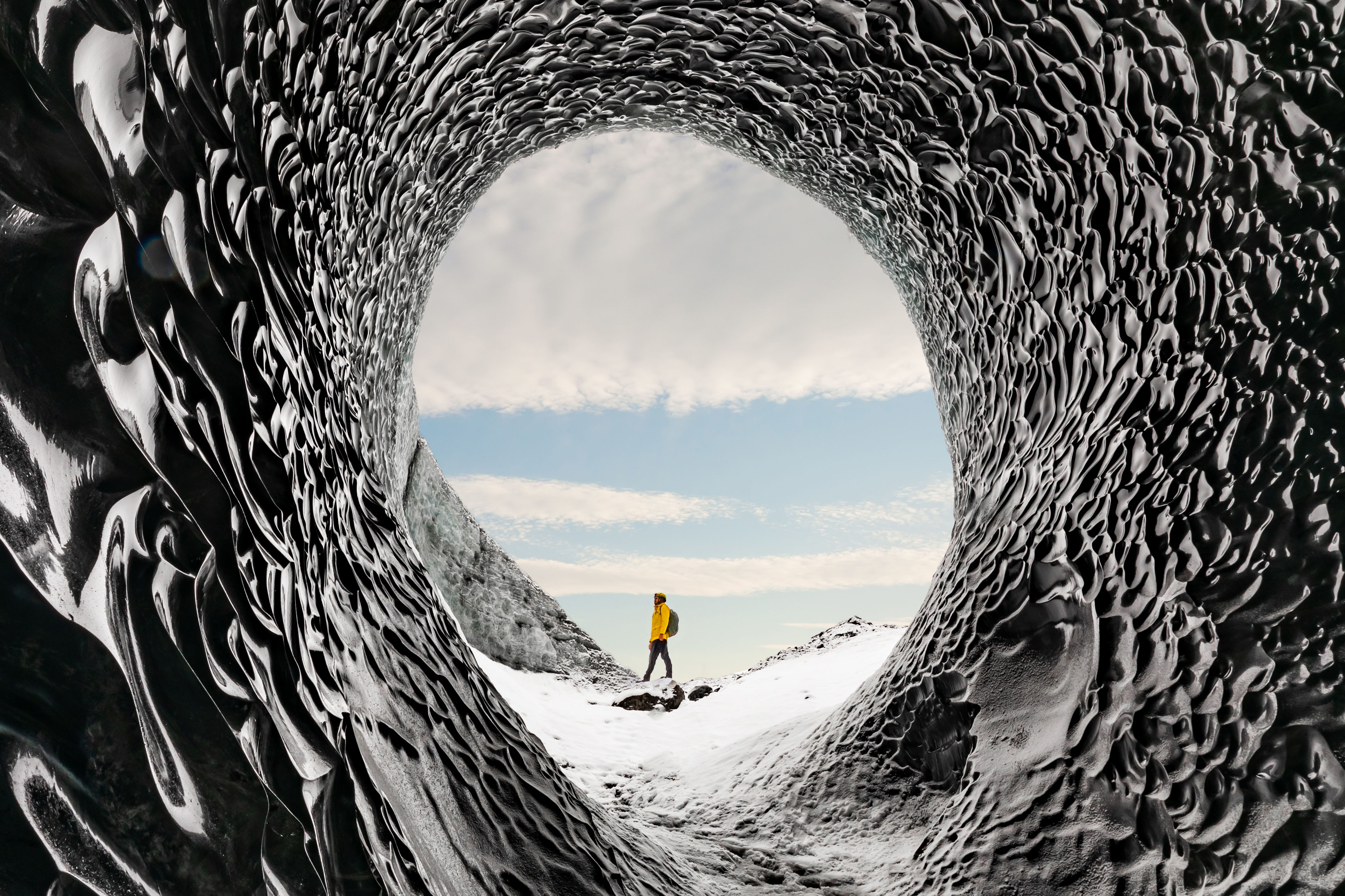 Man exploring amazing glacial cave Iceland