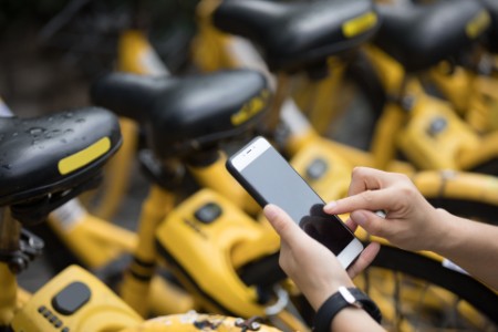 Person using smartphone for bike rental