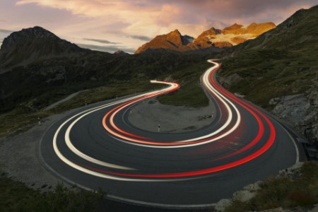Car trails lights on mountain road, Switzerland