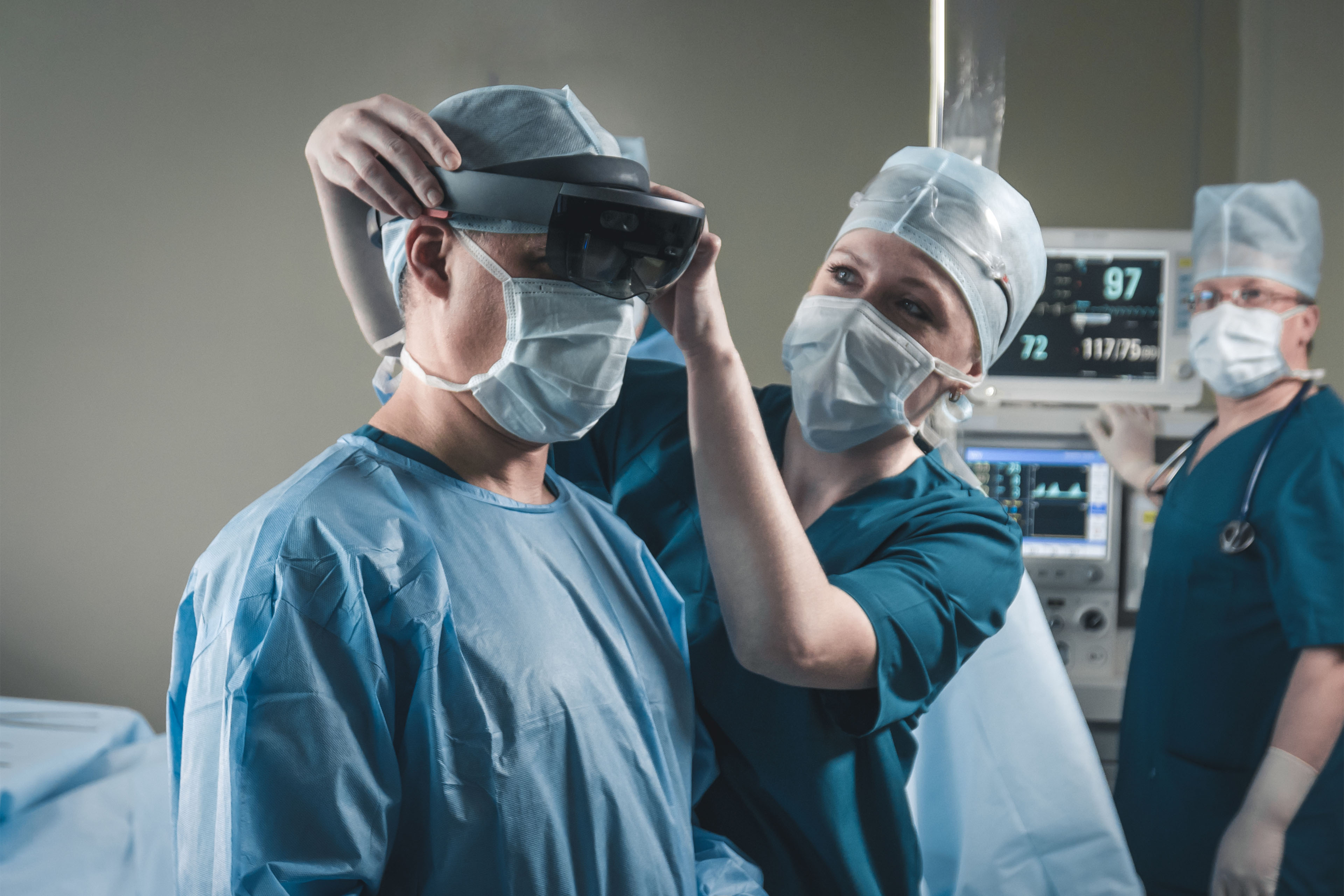 Nurse assisting surgeon with mounting augmented reality holographic