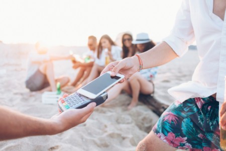 Using smart phone for paying on beach
