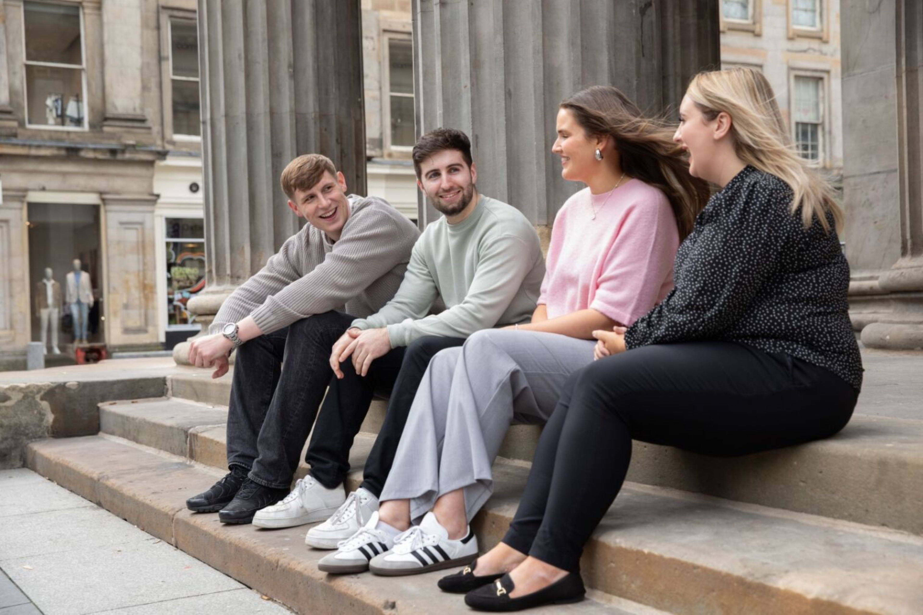EY Students sitting on steps 