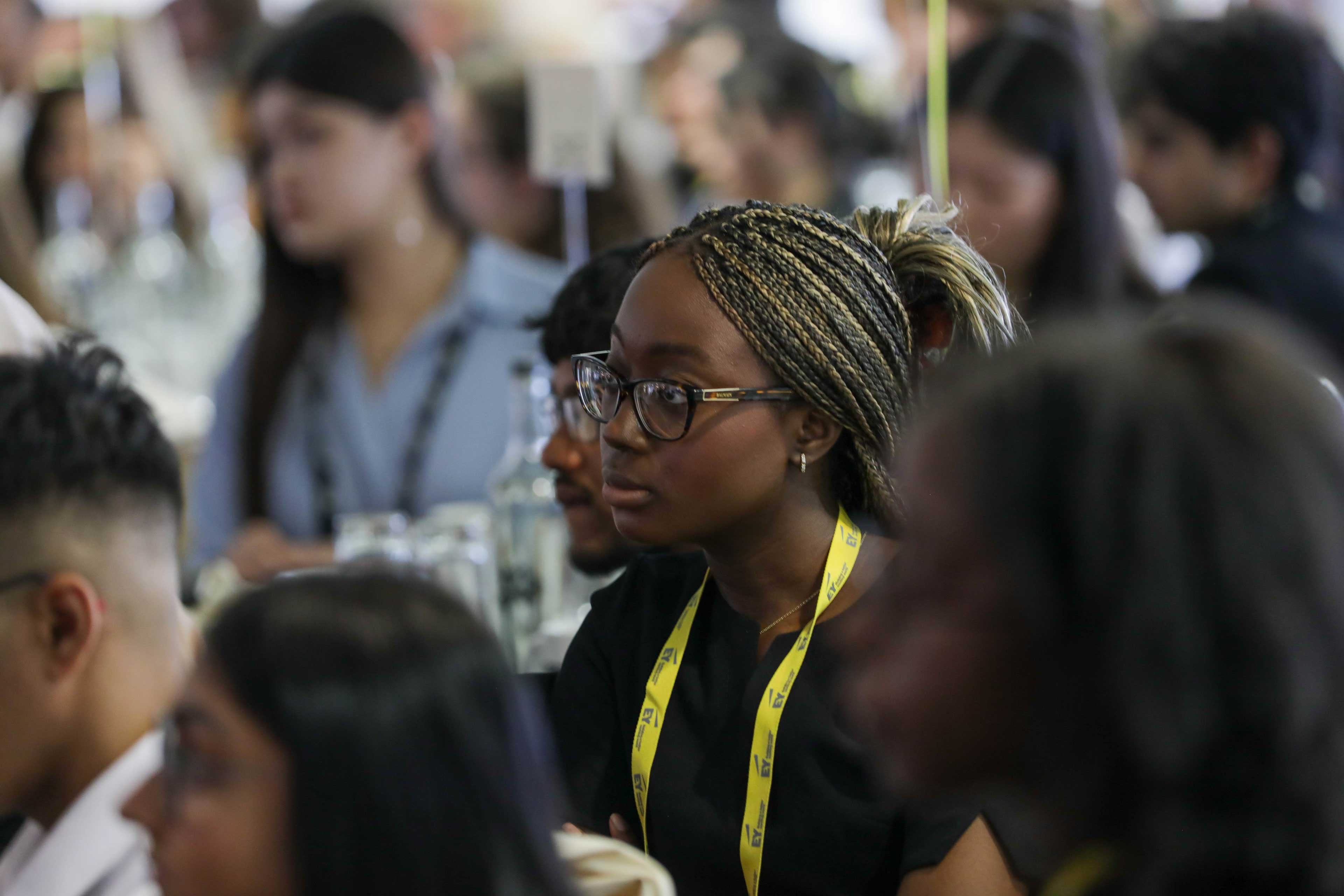 Student sitting at an EY event amongst other peers