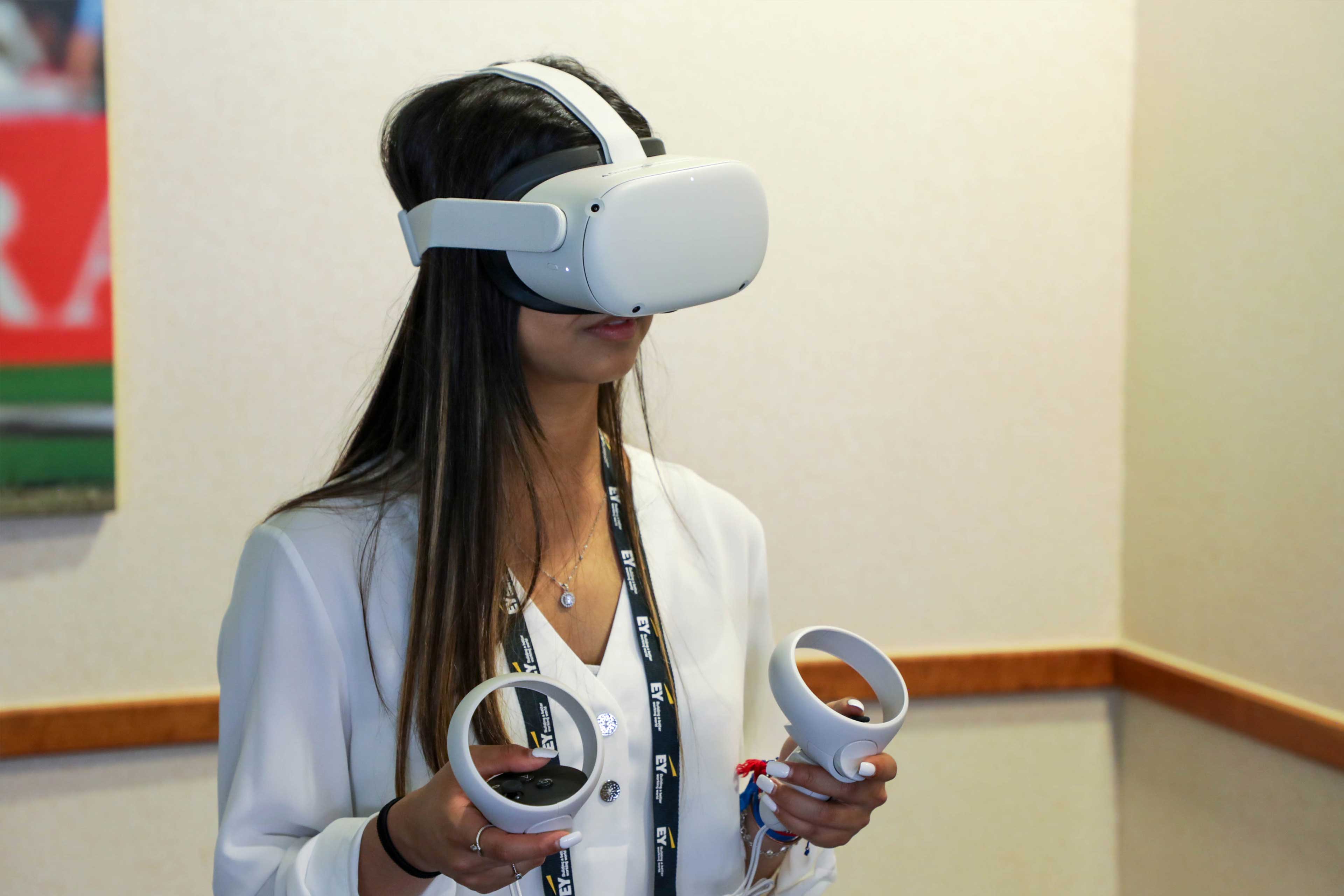 Student with a virtual reality set at an EY event