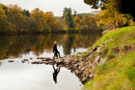 Woman walking in a beautiful landscape near a river