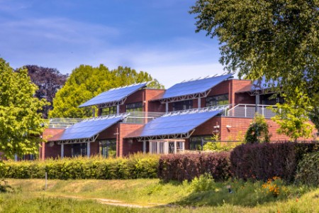 Public school building with solar panels as sun protection