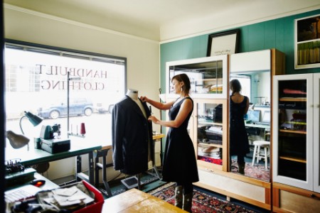 Lady in a shop looking at suit jacket