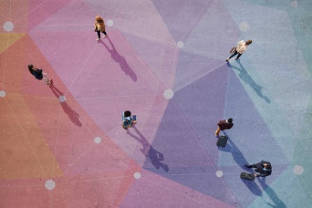 Overhead view of people walking on a colourful floor