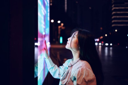 Young woman using touch screen on the street in Shanghai China