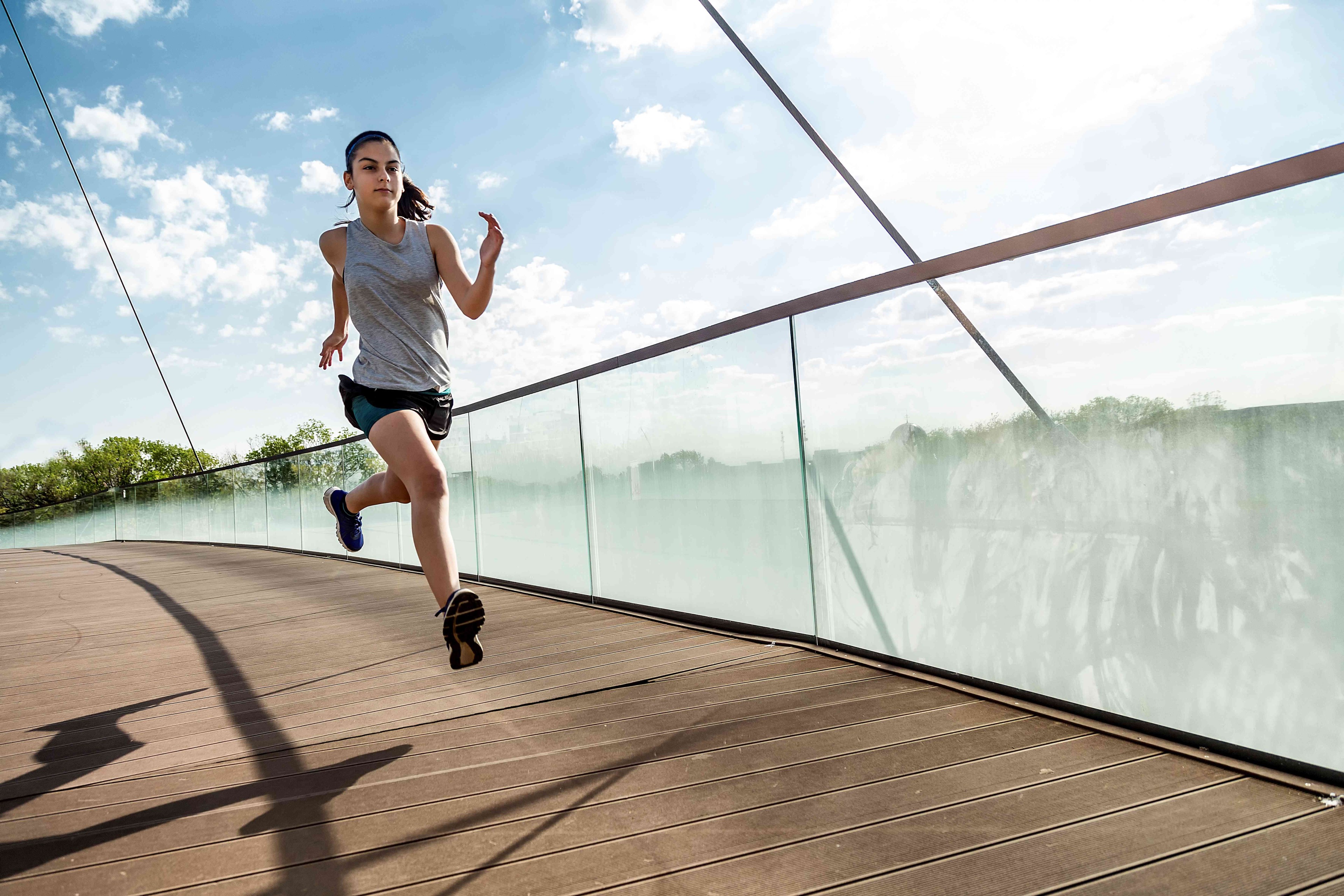 Female athlete running on bridge