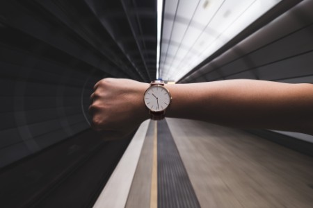 Cropped Image Of Woman Hand Showing Wristwatch At Subway Station
