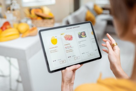Women ordering online grocery via tablet