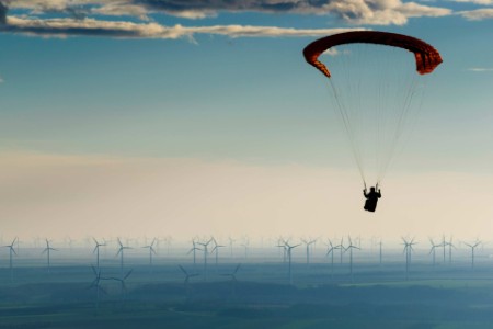EY Hang Glider over Wind Turbines