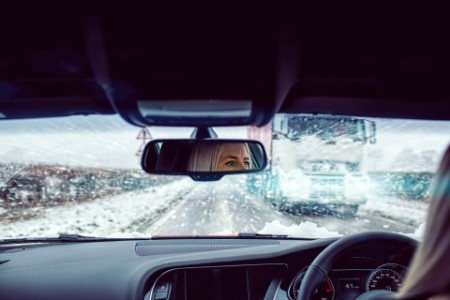 Women driving in a winter storm