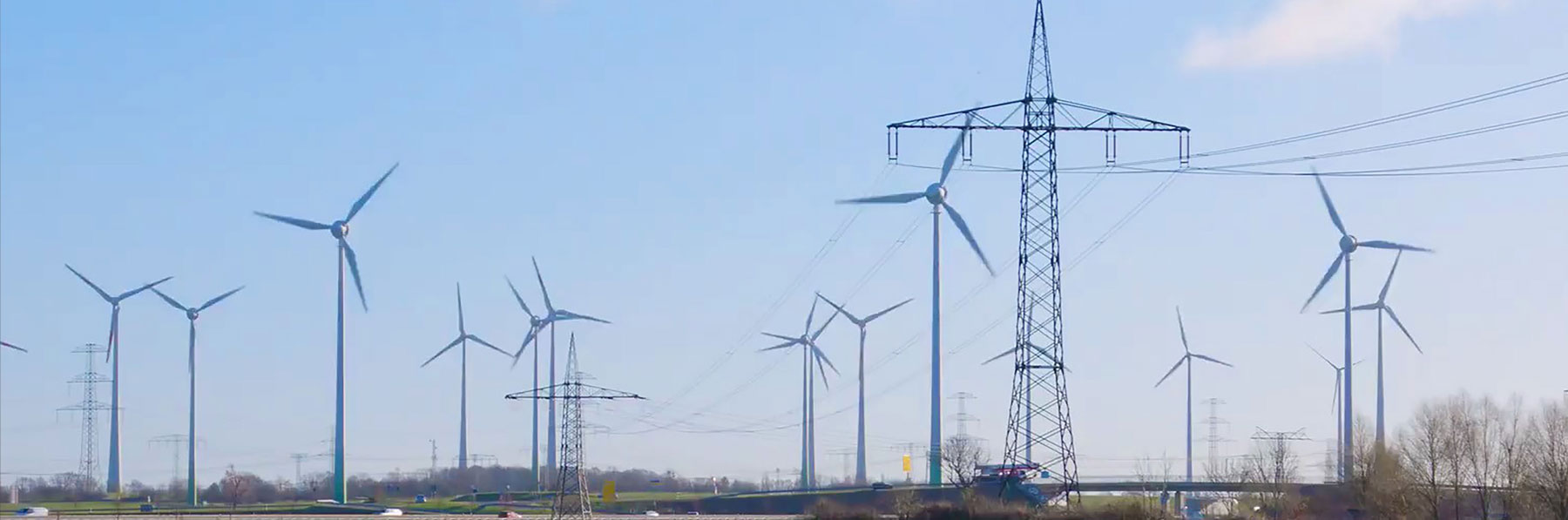 Highway with wind turbines and transmission line thumb