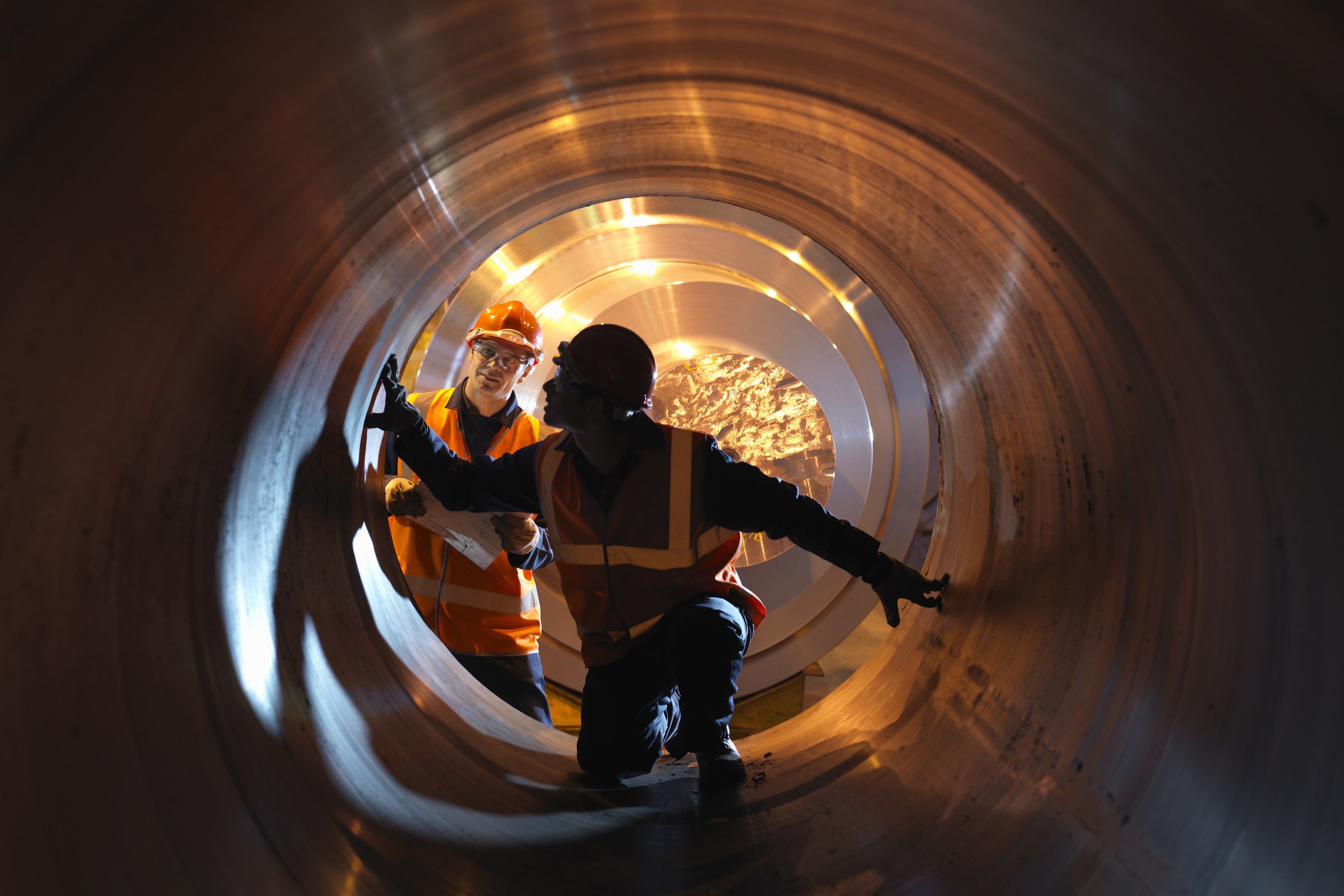 Engineers inspecting forged steel