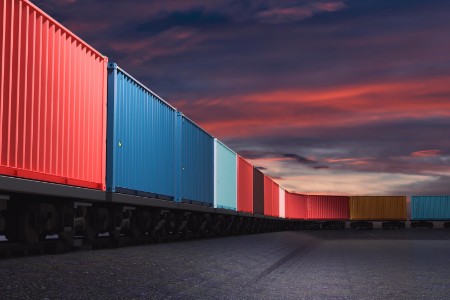 Train carrying containers in warehouse in shipping port