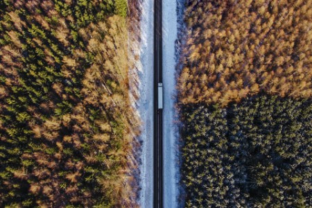 EY - Aerial shot of a truck driving down a highway