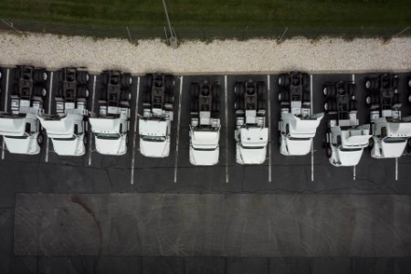 EY - Fleet of white 18 wheeler semi trucks