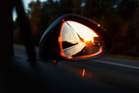 Sunset view through a car side mirror