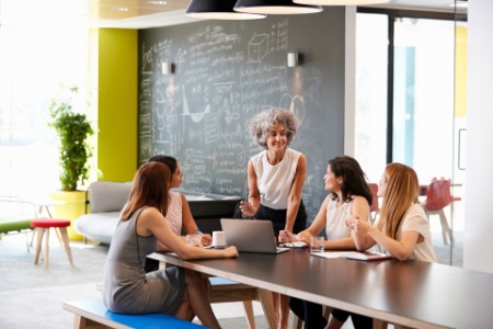 Female boss addressing colleagues