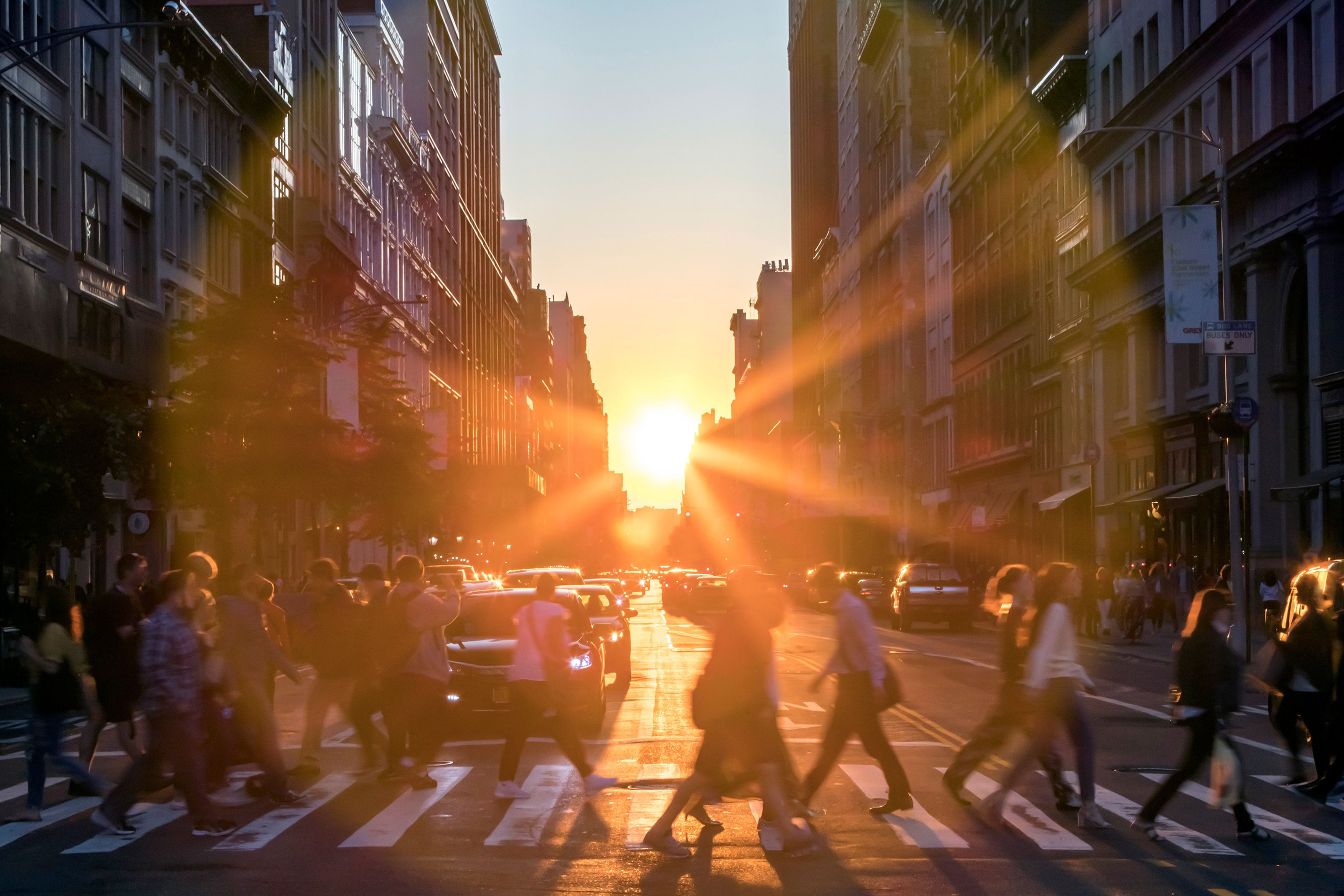 Sunlight rays behind crowds of people in new york city