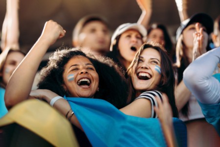 Excited crowd of sports fans celebrating their team's victory