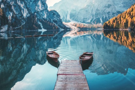 Paddle boats in water with mountain