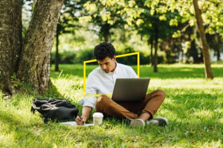 Man using laptop in park
