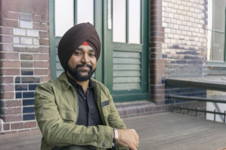 Indian man in front of building