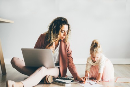 Work from home mother helping daughter