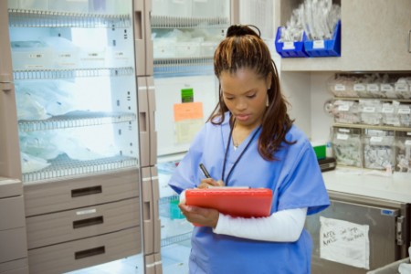 EY - Female nurse in medical supply room