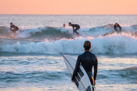 surfer watching his friends surfing