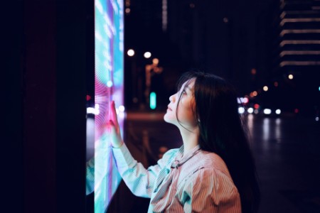 Young woman using touch screen on the street in Shanghai