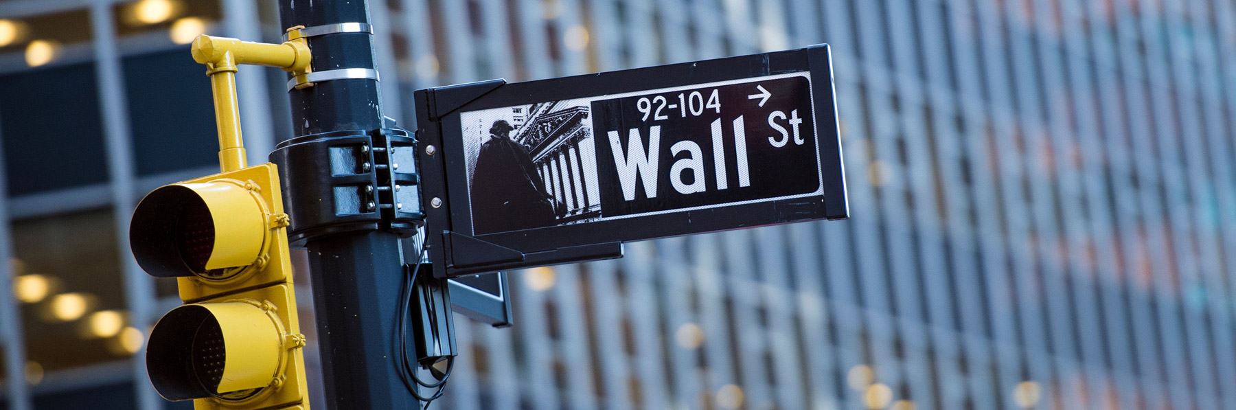 Wall street sign with blurred building