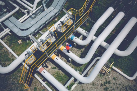 Top view of worker inspecting the valve of pipeline oil and gas