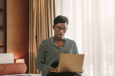 Businesswoman working from hotel room