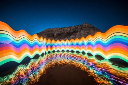 Light painted rainbow reflected on river