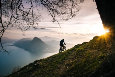 Mountain biker traverses mountain slope
