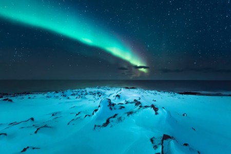 EY northern lights above the beach