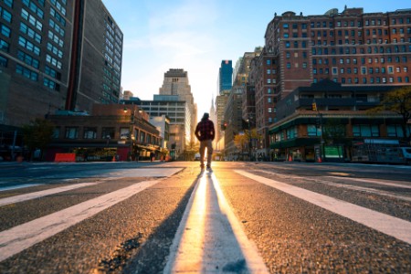 ey-one-person-crossing-a-junction-in-manhattan-at-sunrise-new-york-city