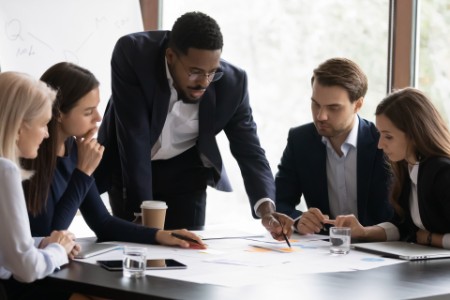 Confident biracial businessman head meeting with diverse colleagues