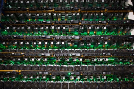 Cryptocurrency mining rigs sit on racks