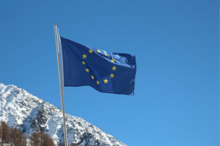 Low Angle View Of European Union Flag Against Snowcapped Mountain