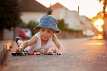 Cute little boy, playing with little toy cars